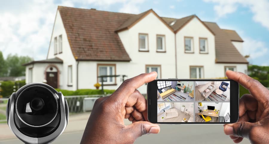 Man holding phone and viewing footage from security cameras