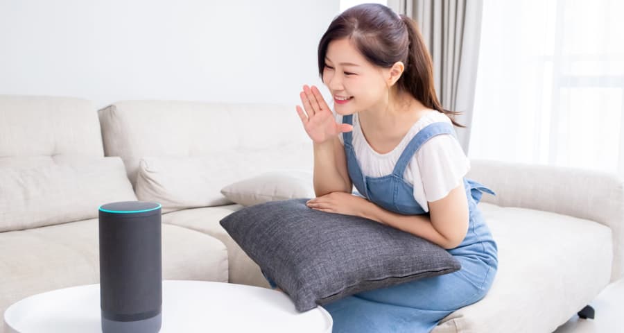 Young woman giving a command to a smart assistant
